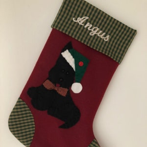 Terrier Christmas Stocking. Dog Christmas stocking with an adorable terrier on the front. Dog is wearing a stocking cap and hand stitched to the front. Stocking is made of high quality felt, lined, personalized and hangs beautifully. Optional colors