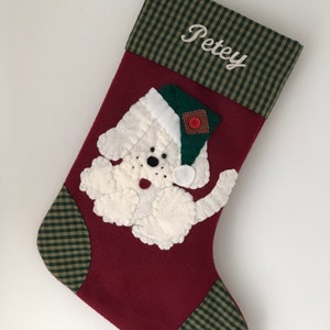 Beautiful dog stocking handmade in the US. This adorable stocking has a dog handstitched to the front of the stocking. The dog stocking is sure to be treasured for years to come. Treat your furry friend with their very own dog stocking.