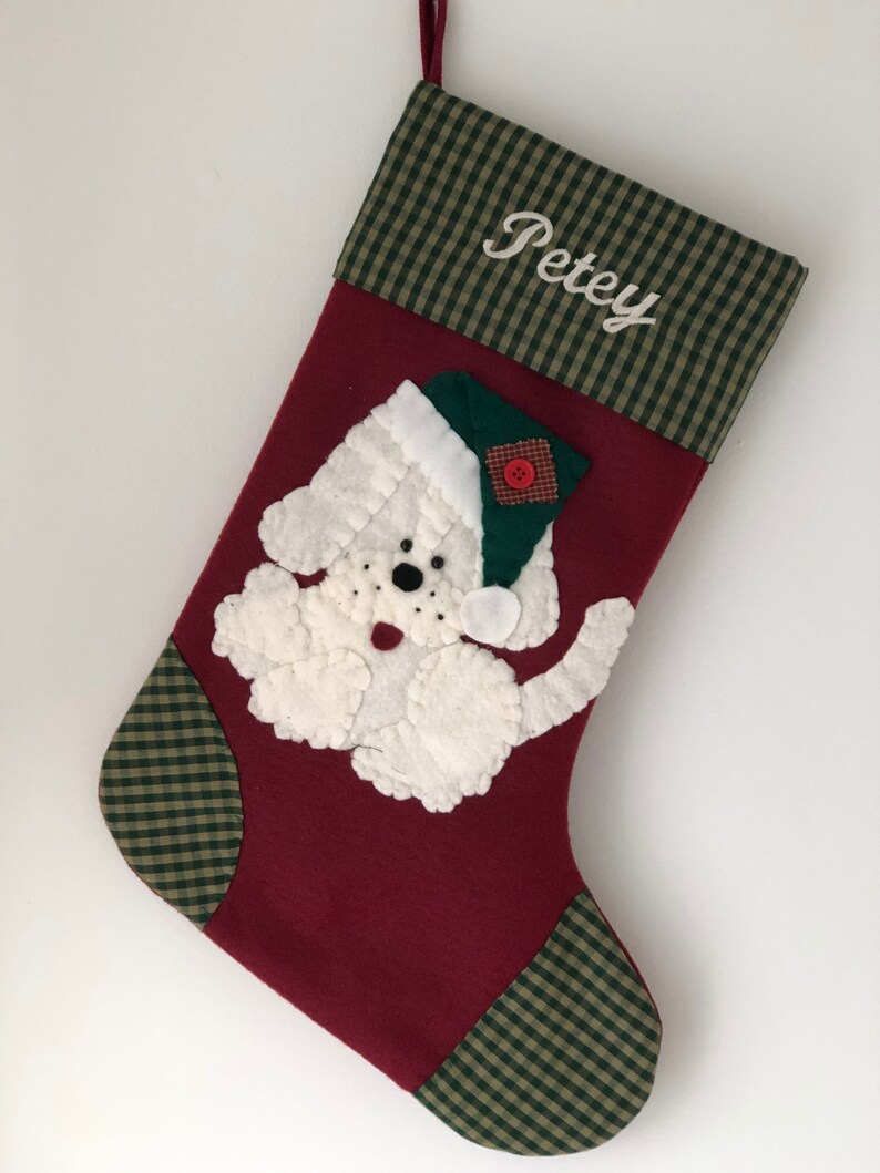 Beautiful dog stocking handmade in the US. This adorable stocking has a dog handstitched to the front of the stocking. The dog stocking is sure to be treasured for years to come. Treat your furry friend with their very own dog stocking.