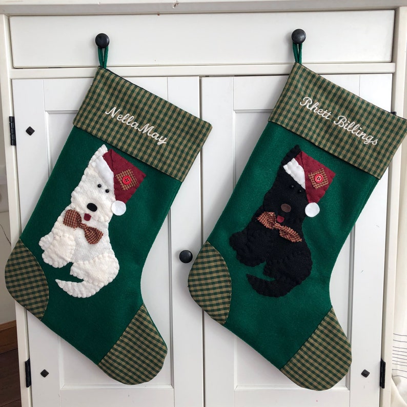 Terrier Christmas Stocking. Dog Christmas stocking with an adorable terrier on the front. Dog is wearing a stocking cap and hand stitched to the front. Stocking is made of high quality felt, lined, personalized and hangs beautifully. Optional colors