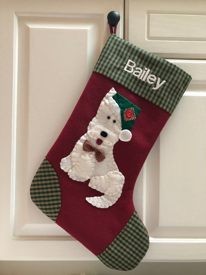 Terrier Christmas Stocking. Dog Christmas stocking with an adorable terrier on the front. Dog is wearing a stocking cap and hand stitched to the front. Stocking is made of high quality felt, lined, personalized and hangs beautifully. Optional colors