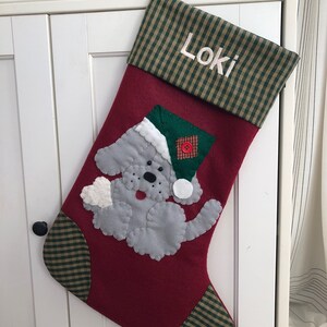 Beautiful dog stocking handmade in the US. This adorable stocking has a dog handstitched to the front of the stocking. The dog stocking is sure to be treasured for years to come. Treat your furry friend with their very own dog stocking.