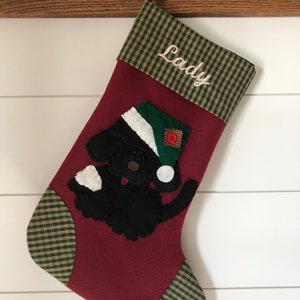 Beautiful dog stocking handmade in the US. This adorable stocking has a dog handstitched to the front of the stocking. The dog stocking is sure to be treasured for years to come. Treat your furry friend with their very own dog stocking.