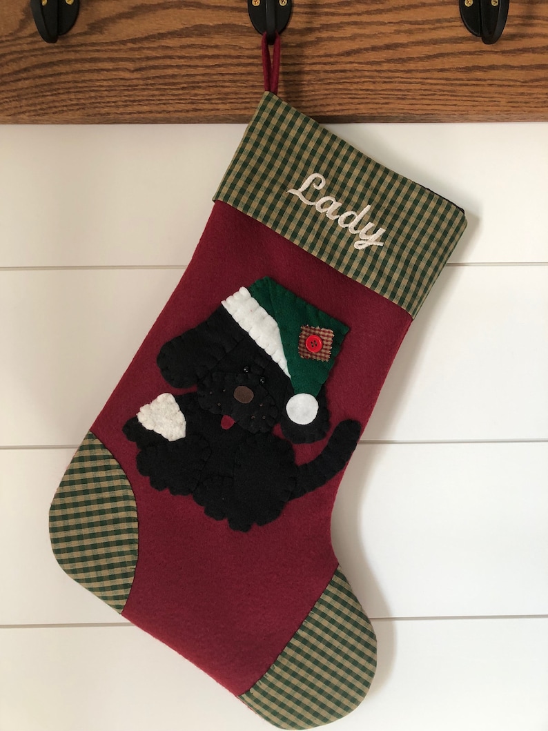 Beautiful dog stocking handmade in the US. This adorable stocking has a dog handstitched to the front of the stocking. The dog stocking is sure to be treasured for years to come. Treat your furry friend with their very own dog stocking.