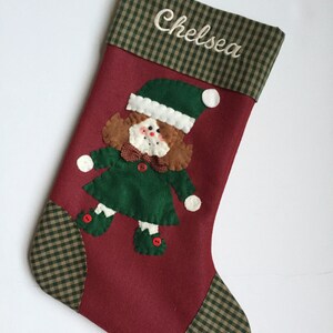 Christmas stocking with a girl elf hand-stitched to the front. Multiple hair colors to choose from. This Elf Christmas stocking is made of high quality felt, lined, personalized and hangs beautifully. Christmas stocking to treasure for years to come.