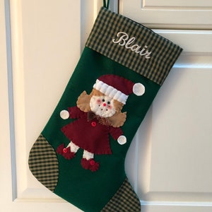 Christmas stocking with a girl elf hand-stitched to the front. Multiple hair colors to choose from. This Elf Christmas stocking is made of high quality felt, lined, personalized and hangs beautifully. Christmas stocking to treasure for years to come.