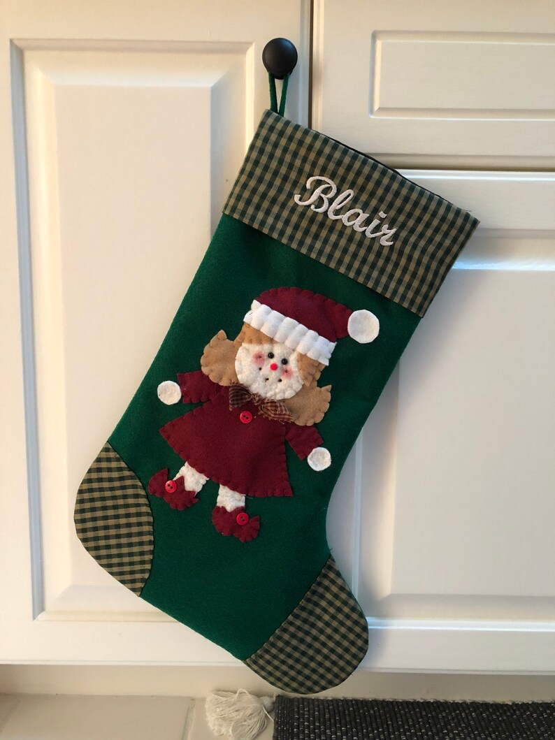 Christmas stocking with a girl elf hand-stitched to the front. Multiple hair colors to choose from. This Elf Christmas stocking is made of high quality felt, lined, personalized and hangs beautifully. Christmas stocking to treasure for years to come.