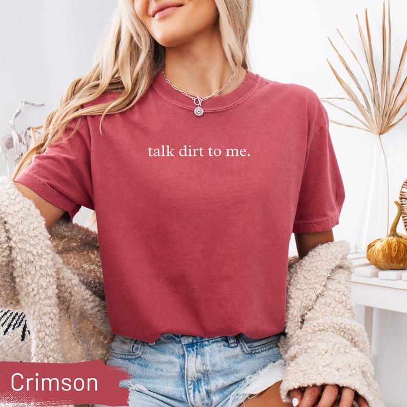 Crimson t-shirt with "talk dirt to me." text and distressed denim shorts.