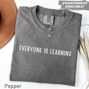 May include: A rustic wooden sign with the text "Welcome to our home" in white lettering. The sign features a distressed finish and a simple, inviting design, perfect for entryway decor.