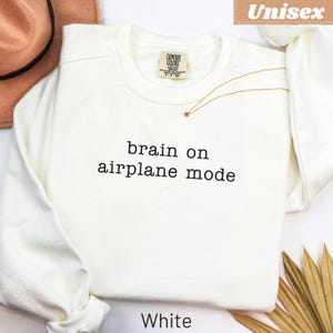 White Comfort Colors sweatshirt with "brain on airplane mode" text.