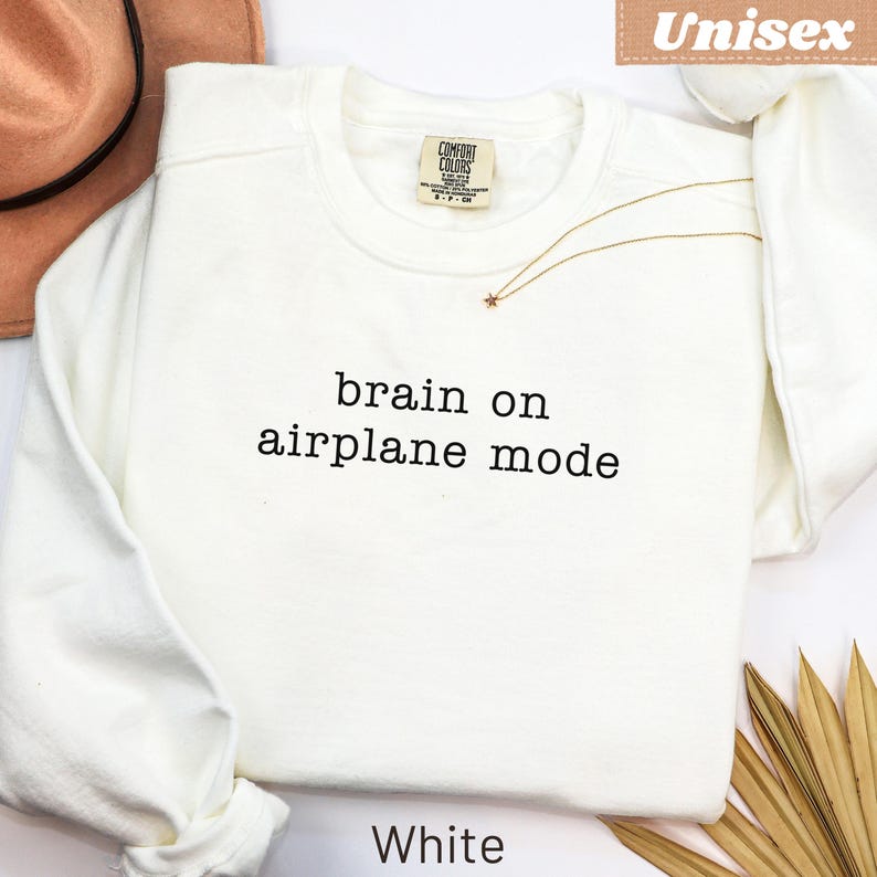 White Comfort Colors sweatshirt with "brain on airplane mode" text.