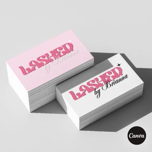 May include: Two stacks of rectangular business cards. One stack is light pink, the other is white. Both feature the text LASHED in a bold, pink, retro-style font with a small star icon, and the script text by Brianna in black or white.