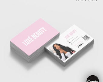 May include: Two stacks of rectangular business cards. The top card in the left stack is light pink with the white text LUXÉ BEAUTY. The right stack shows a card with a photo of a person, the text LUXÉ BEAUTY, contact details, and a QR code.