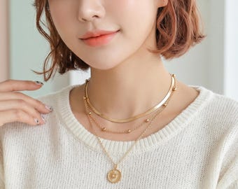 Gold multi-strand necklace with elegant sun pendant