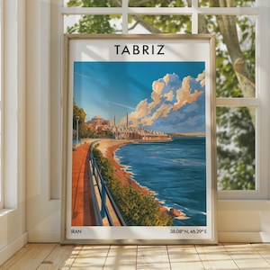 May include: A framed travel poster featuring a stylized illustration of Tabriz, Iran, with a coastal walkway, blue water, and a city skyline under a cloudy sky. The text TABRIZ is at the top, and IRAN 38.08 N, 46.29 E is printed at the bottom.