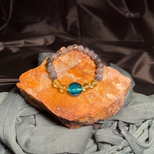 Luminous 7.5” stretchy bracelet made from repurposed glass beads.