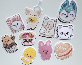 May include: A selection of vibrant stickers showcasing cartoon characters and food. The stickers depict a bunny, a wolf, a bear in a cupcake, a duck, a mouse, a dog with floral decorations, a pink bunny, and a heart-shaped macaron.