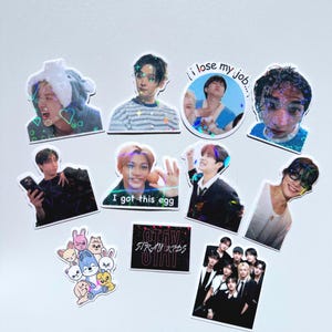 May include: A collection of stickers featuring images of people, cartoon characters, and text. The stickers include images of people with text such as "I got this egg" and "I lose my job...", and a sticker with the text "STRAY KIDS STAY".