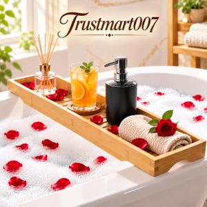 May include: A rectangular bamboo bathtub tray resting over a white tub filled with bubble bath and scattered red rose petals. The tray holds a glass reed diffuser, a glass of orange citrus drink, a black soap dispenser, and a beige towel with a red rose.