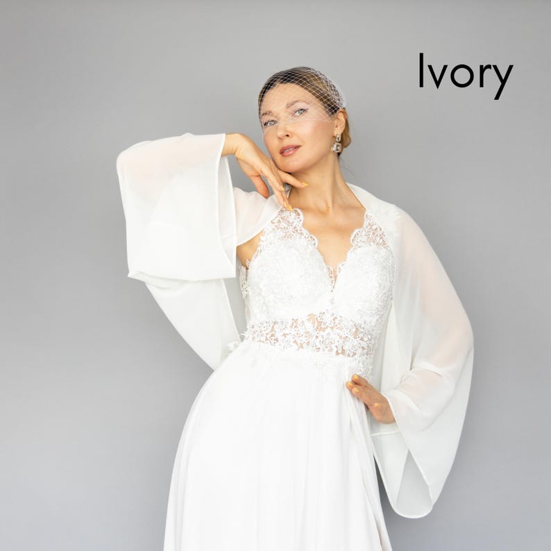 May include: A white chiffon bridal shawl with a lace bodice and a veil. The text "Ivory" is visible in the upper right corner of the image.