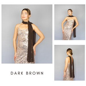 May include: A dark brown scarf draped over a sequined gold dress. The image shows a woman wearing the scarf and dress in multiple poses. The text "DARK BROWN" is at the bottom of the image.