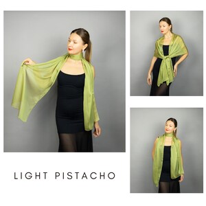 May include: A light pistachio-coloured scarf is draped around a person's neck and shoulders. The scarf is made of a lightweight, flowing fabric. The text "LIGHT PISTACHO" is displayed at the bottom of the image.