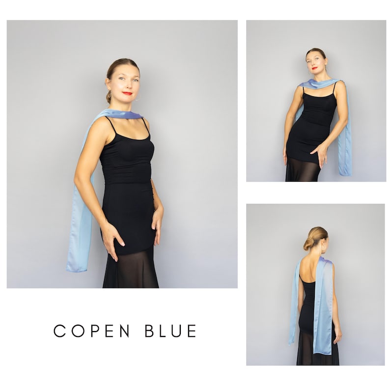 May include: A light blue scarf draped over a black dress. The scarf is a solid color and appears to be made of a silky material. The text "COPEN BLUE" is displayed in a sans-serif font at the bottom of the image.
