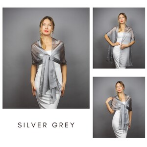 May include: A silver-grey sheer shawl worn over a white dress. The shawl is tied in a bow at the front, with long flowing panels. The text "SILVER GREY" is displayed at the bottom of the image. The image is composed of multiple views of the same item.