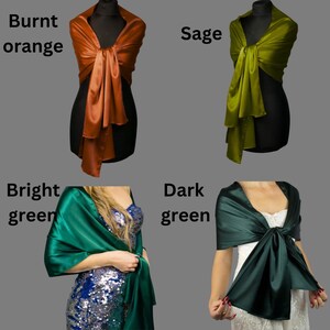 May include: Four different colored satin scarves, displayed on mannequins. The scarves are in the colors burnt orange, sage green, bright green, and dark green.