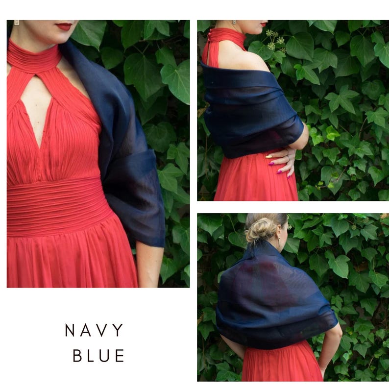 May include: A navy blue sheer shawl draped over a red dress. The shawl is made of a lightweight fabric and is perfect for adding a touch of elegance to any outfit.
