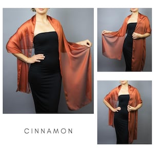 May include: A flowing, cinnamon-coloured shawl worn over a black dress. The sheer fabric is lightweight. The word "CINNAMON" is printed at the bottom. The shawl is shown from multiple angles. The fabric appears to be approximately 180 cm long.