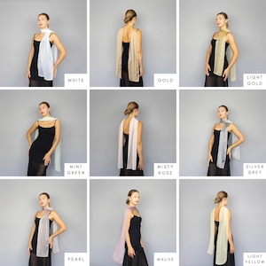 May include: A collection of sheer scarves in various colors, including white, gold, light gold, mint green, misty rose, silver grey, pearl, mauve, and light yellow. Each scarf is draped over a black dress. The colors are labeled with text.