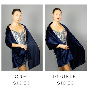 May include: A navy blue velvet wrap, shown one-sided and double-sided. The wrap is draped over a silver sequin dress. The text "ONE-SIDED" and "DOUBLE-SIDED" is shown below the wrap.