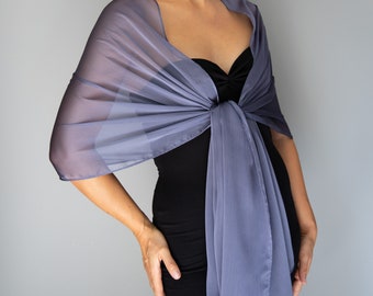 May include: A sheer, lavender-blue shawl draped over a black dress. The shawl is knotted at the waist and has a flowing, elegant design. The fabric appears lightweight and suitable for formal occasions.