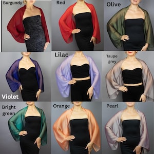 May include: A collection of nine sheer chiffon shawls in various colors, including burgundy, red, olive, lilac, taupe grey, violet, bright green, orange, and pearl. The shawls are draped over the shoulders of models wearing black dresses.