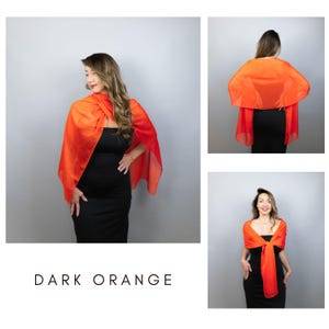 May include: A dark orange shawl draped over a black dress. The shawl is made of a sheer fabric and is styled in multiple ways. The text "DARK ORANGE" is displayed at the bottom of the image.