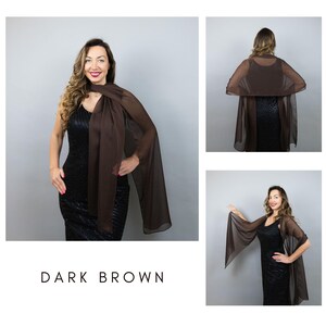 May include: A dark brown sheer shawl draped over a black dress. The shawl is long and flowing, with a rectangular shape. The text "DARK BROWN" is displayed at the bottom of the image.