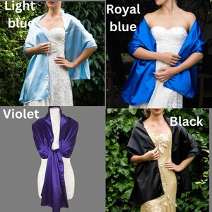 May include: Four different colors of satin shawls, light blue, royal blue, violet, and black. The shawls are draped over mannequins and are shown in different poses.