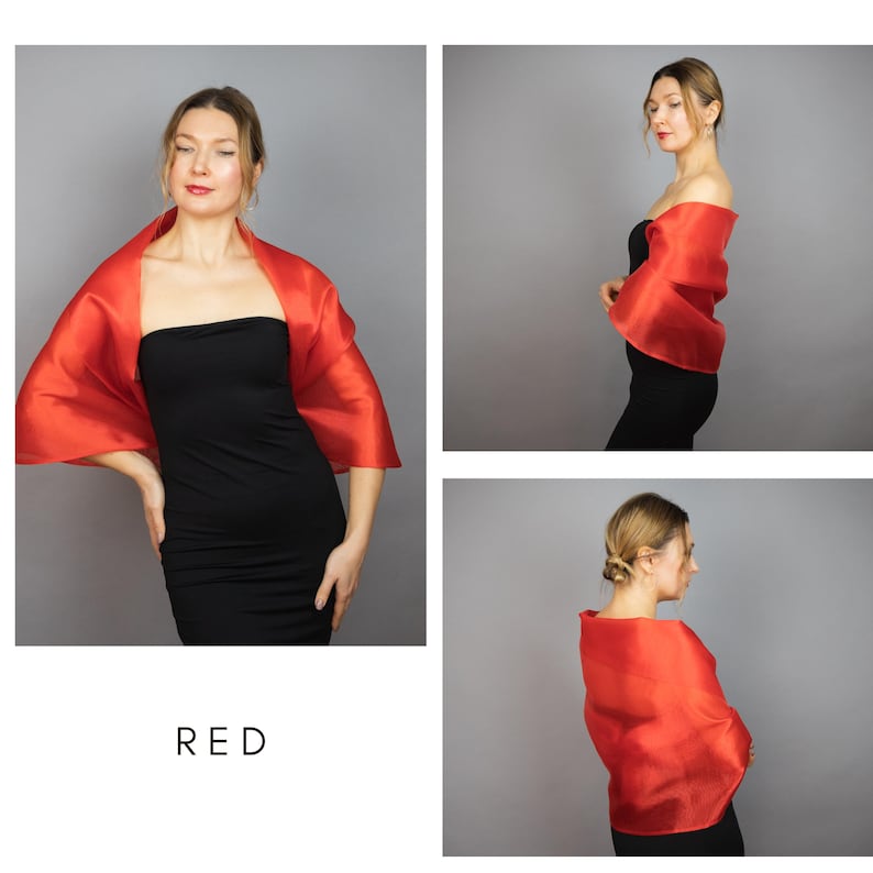 May include: A red silk shawl draped over a person's shoulders. The shawl is made of a lightweight, flowing fabric and has a simple, elegant design. The model is wearing a black dress.