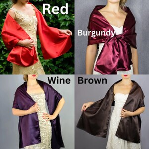 May include: Four satin shawls in different colors: red, burgundy, wine, and brown. The shawls are draped over the shoulders of four models.