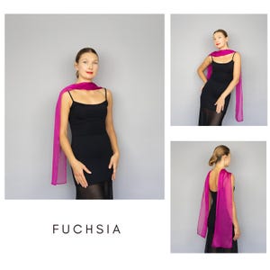 May include: A fuchsia-colored scarf draped over a black dress. The scarf is a vibrant pink hue and appears to be made of a lightweight, sheer fabric. The word "FUCHSIA" is printed in white at the bottom of the image.