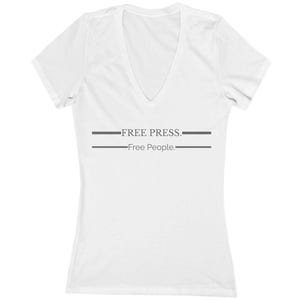 May include: White V-neck t-shirt with short sleeves. The shirt features the text "FREE PRESS." above "Free People." in gray, with a horizontal line above and below the text. The shirt is made of a soft material.