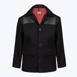 May include: A black jacket featuring a pointed collar, three front buttons, and two large flap pockets. The shoulders have smooth black panels, and the interior is lined with a red, black, and white tartan pattern with a Combat brand label.