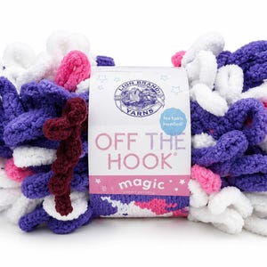 May include: A skein of Lion Brand Off The Hook Magic yarn featuring a looped texture in a color palette of purple, white, and pink. The central paper label displays the brand logo, the text Off The Hook, and the word magic with star accents.