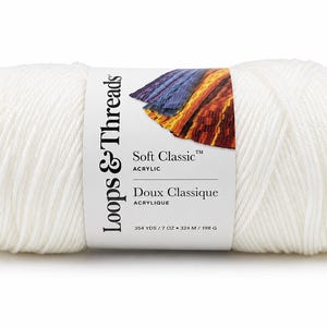 May include: A skein of solid white acrylic yarn with a paper label reading Loops & Threads Soft Classic Acrylic, 354 yds / 7 oz. The label features a colorful graphic of a knitted fabric swatch in shades of purple, blue, orange, and yellow.