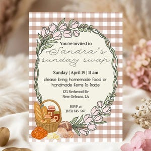 May include: An invitation for Sandra's Sunday swap, featuring a floral wreath and a basket of baked goods. The text reads "You're invited to Sandra's Sunday swap" with the date, time, and location. The invitation is on a beige and brown checkered background.