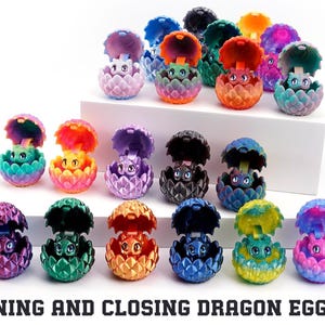 May include: A collection of small, multi-coloured plastic dragon figurines, each housed within a textured, hinged egg that opens and closes. The dragons feature various solid and gradient colours, including purple, green, orange, blue, and black.