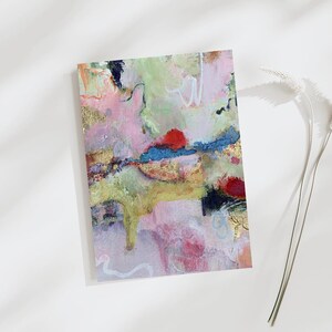 May include: Abstract art print with a colorful, textured design. The artwork features a mix of pink, green, yellow, and blue hues with gold accents. The piece has a layered appearance with visible brushstrokes and a modern aesthetic.