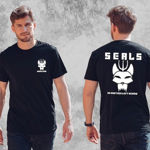 May include: A black short-sleeved t-shirt featuring a white graphic on the chest that reads BRAVO TEAM with a trident skull logo. The back displays the text SEALS above a larger trident skull logo and the phrase NO BROTHER LEFT BEHIND.