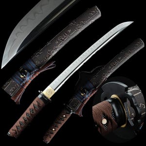 May include: A Japanese katana sword with a curved, silver blade and a brown handle wrapped in a diamond pattern. The scabbard is black with etched designs and blue and brown decorative ties. The sword is displayed against a black background.
